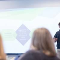 A student presents to the audience.